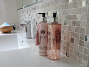 Bathroom renovation. White vanity with a cream and gold splashback